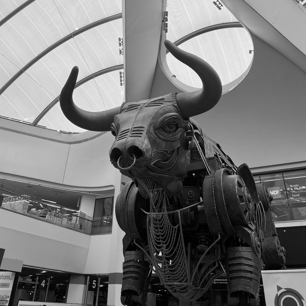 A black and white image of a gigantic metal bull