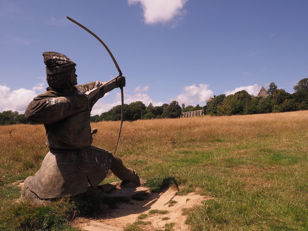 A wooden scupplture of an archer on the battlefield