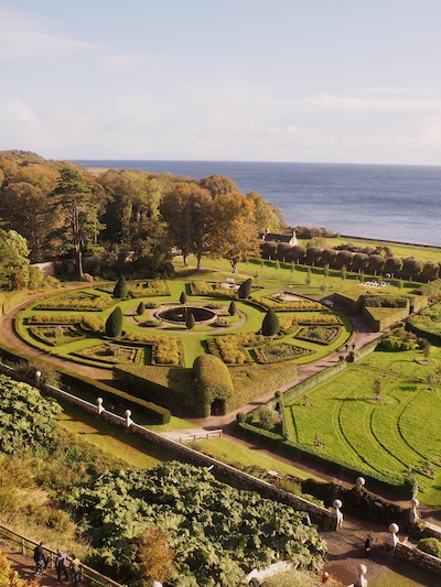 A view from Urquhart of the gardens with the sea in the background
