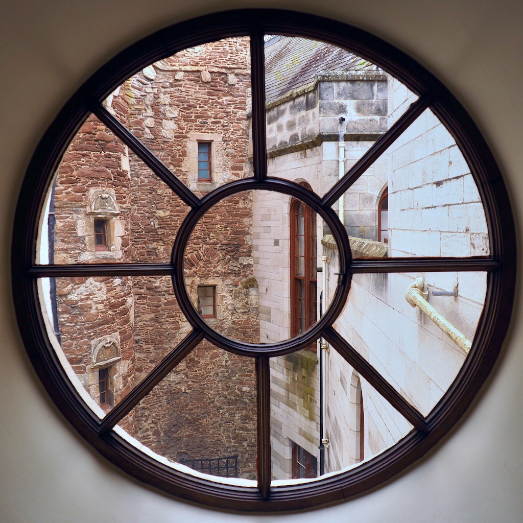 A view of the inside courtyard of Dunrobin castle through a circular window