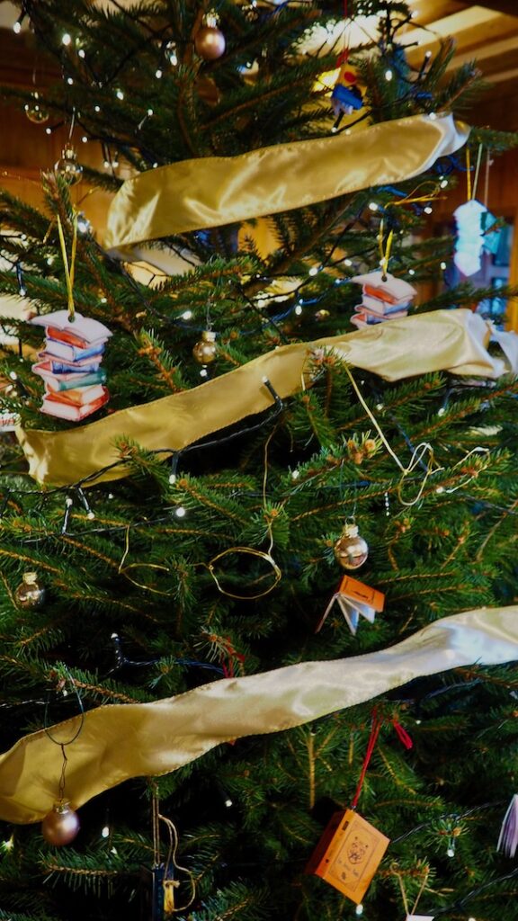 A close up of a tree with glasses and books as decorations