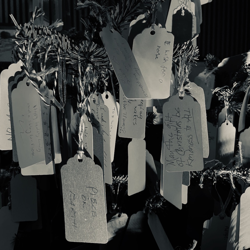 Wishes hanging from a tree handwritten on tags
