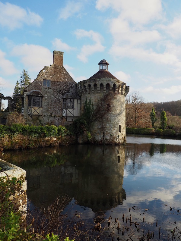 A ruined castle reflected in a moat