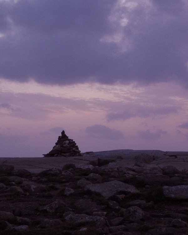 A cairn in front of a sunset