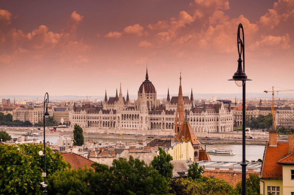A landscape of Budapest with an orange sky